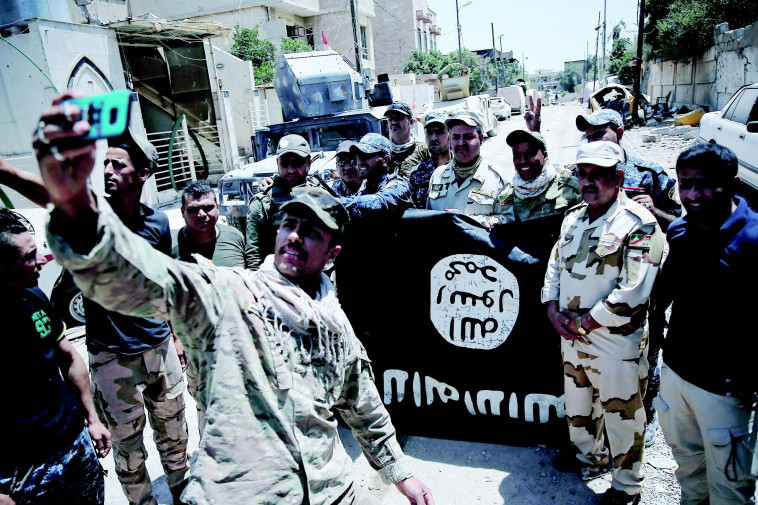 חיילים עיראקיים לאחר כיבוש מוסול. צילום: רויטרס