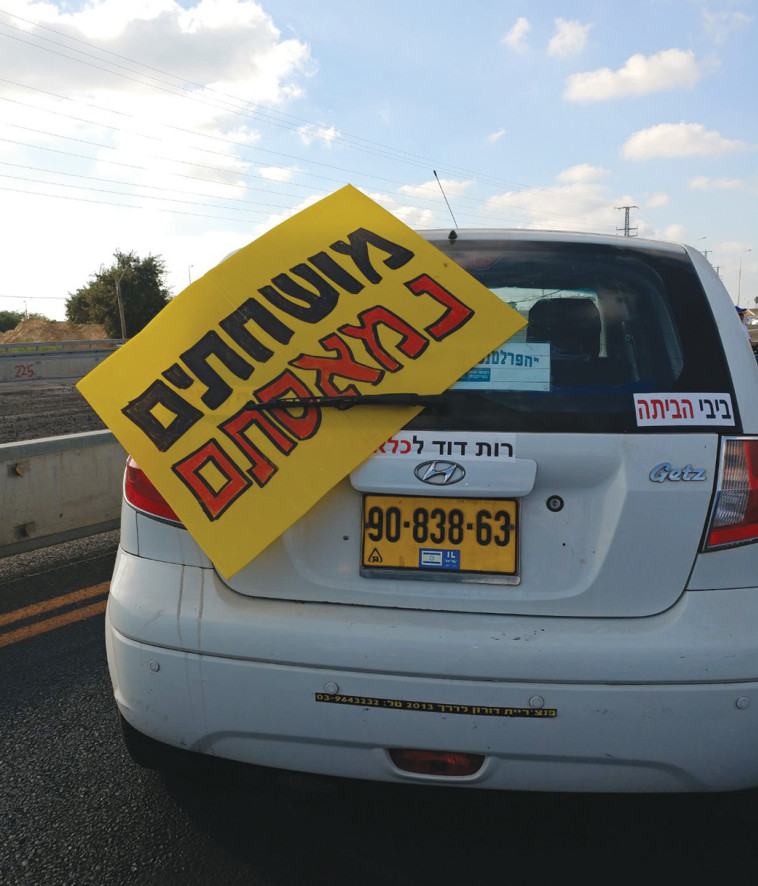 שלטי &quot;מושחתים הביתה&quot; ו&quot;ביבי הביתה&quot;. &quot;לא יכולה לראות את החיוכים של רה&quot;מ&quot;. צילום: מטה מאבק הנכים