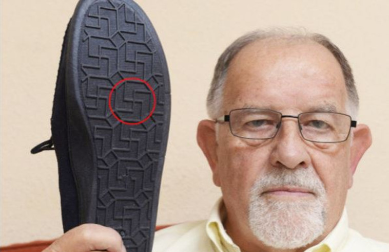 &quot;בהחלט לא אנעל אותן יותר&quot;. סם פרדי ונעלי הבית עם צלבי הקרס. צילום: SWNS 