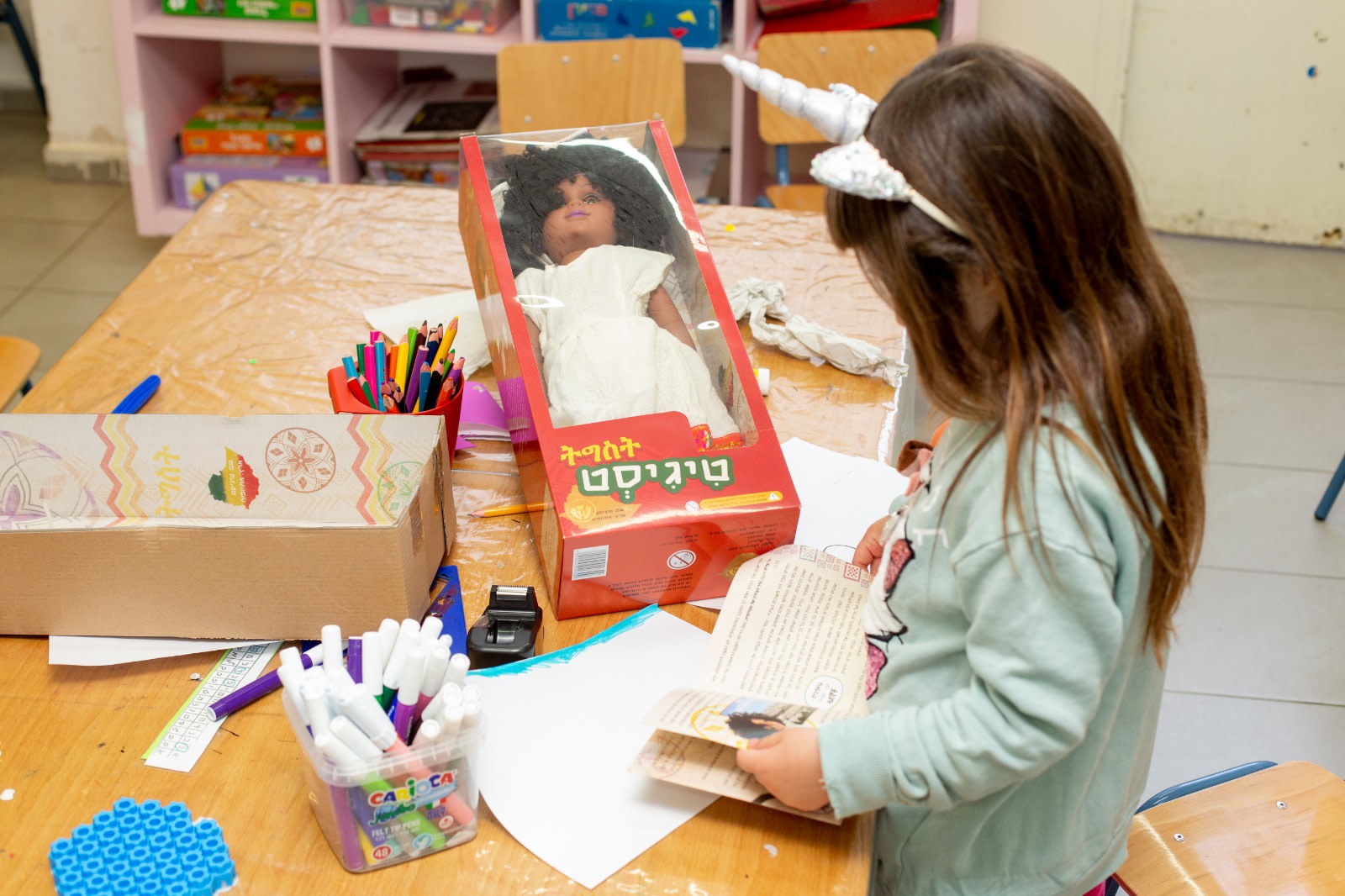 ילדה עם הבובה "טיגיסט". צילום: גדעון אגז'ה