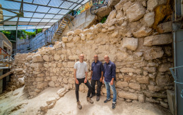 מנהלי החפירה עם קטע החומה שנחשף (צילום: קובי הראתי, עיר דוד)