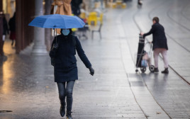 חורף, קור, אנשים עם מטריות בגשם (צילום: יונתן זינדל, פלאש 90)