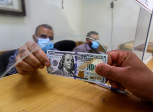 דולר עובר מיד ליד (צילום: עבד רחים כתיב, פלאש 90)