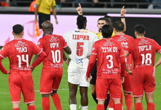 השופט שניר לוי ליד שחקני הפועל חיפה ושחקן הפועל תל אביב, פרנן מאיימבו (צילום: ברני ארדוב)