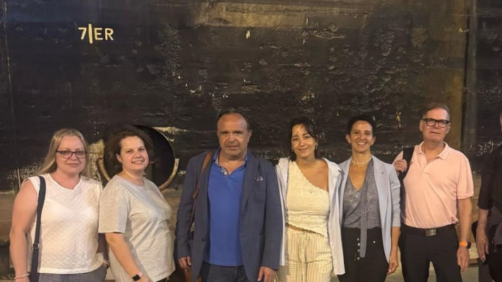 צוות רמב''ם שחזר לישראל, על רקע אוניית החילוץ של ''צים'' (צילום: צים)