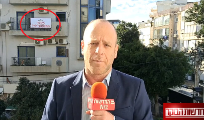 Live: The sign on the balcony behind Yoav Even has become a marriage proposal  Watch