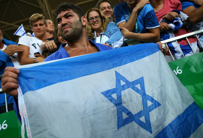 אורי ששון ודגל ישראל (צילום:  רויטרס)