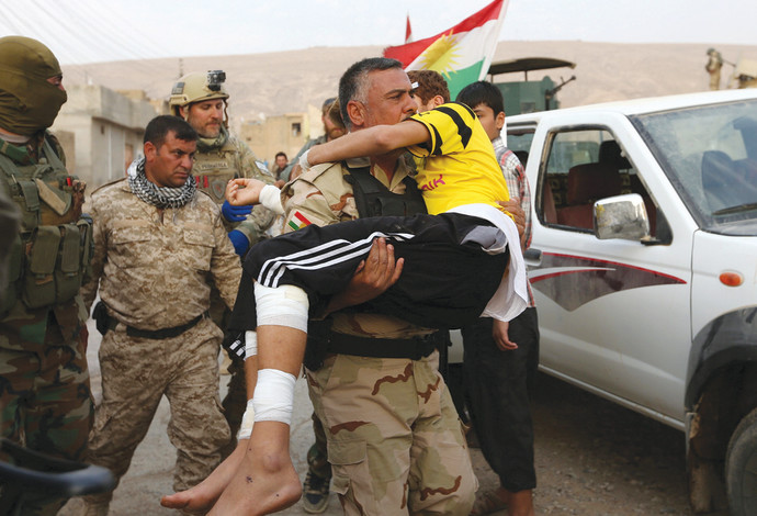 חיילים כורדים ונער פצוע, הלחימה בדאעש (צילום:  רויטרס)
