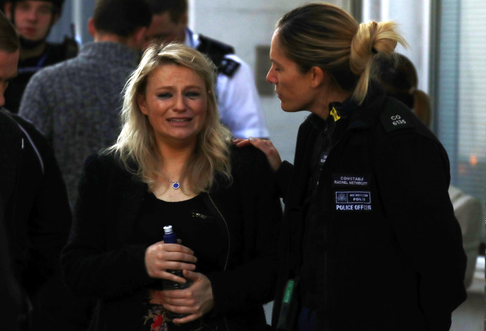 שוטרת מנחמת אישה לאחר הפיצוץ בלונדון (צילום:  רויטרס)
