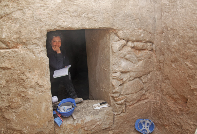 ליאת עוז בכניסה למערת הקבורה (צילום:  יותם אשר, רשות העתיקות)
