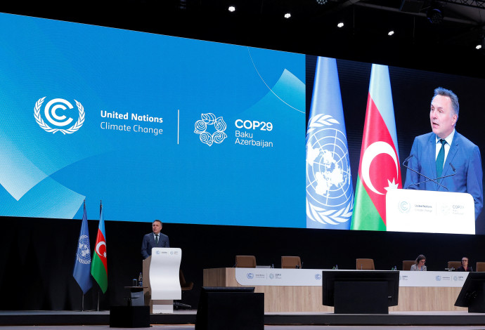 ועידת האקלים COP29 בבאקו. על רקע התמונה, שר הסביבה והאקלים הנוורוגי  (צילום:  רויטרס)