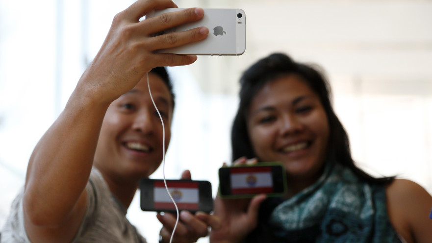 אנשים מסתכלים על האייפון SE בחנות של אפל בטוקיו