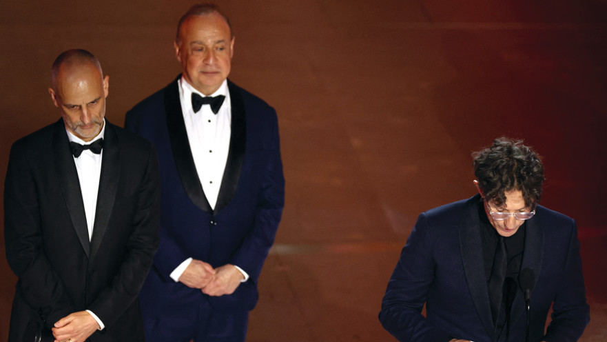 הבמאי היהודי-בריטי ג'ונתן גלייזר קורא מתוך דף את נאום הזכייה שלו