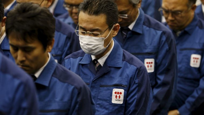 עובדי החברה שיצרו את הכור שנהרס עומדים בדקה הדומייה לאסון, היום. צילום: רויטרס