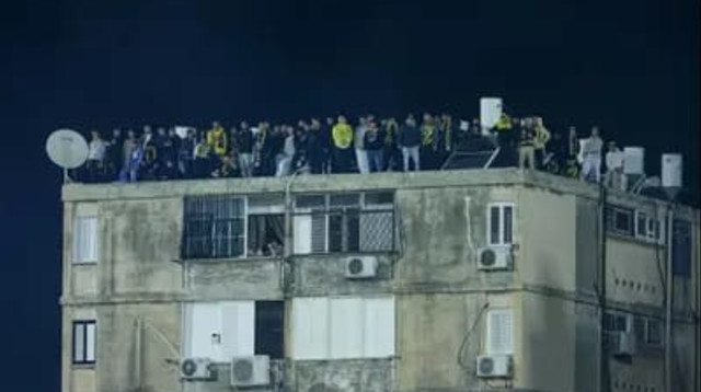 אוהדי בית"ר על הגגות בסמוך לאצטדיון הי"א (צילום: לירון מולדובן)