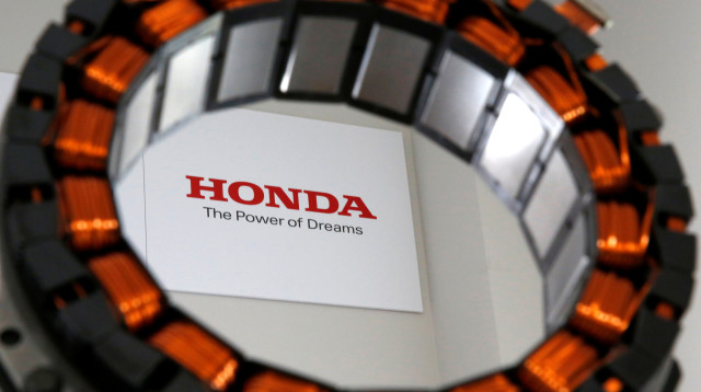 מנוע שיוצר ביפן על ידי מתכות נדירות, על רקע הלוגו של הונדה (צילום: רויטרס)
