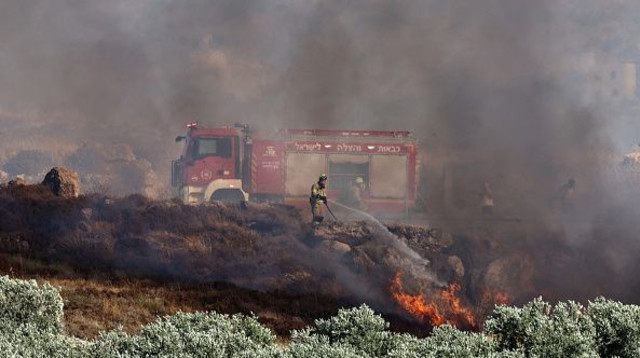 לוחמי אש בפעולה, אילוסטרציה (צילום: Zain JAAFAR / AFP via Getty Images)