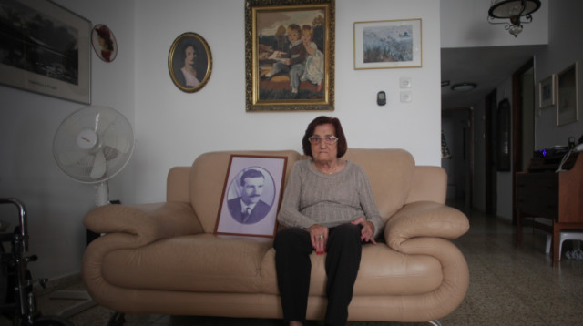 שרה ענתבי עם תמונתו של אחיה, אלי כהן (צילום: רענן כהן)