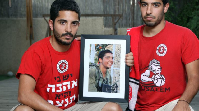 אור (מימין) וציון גדעוני עם תמונתו של ליאל ז"ל (צילום: אריאל בשור)