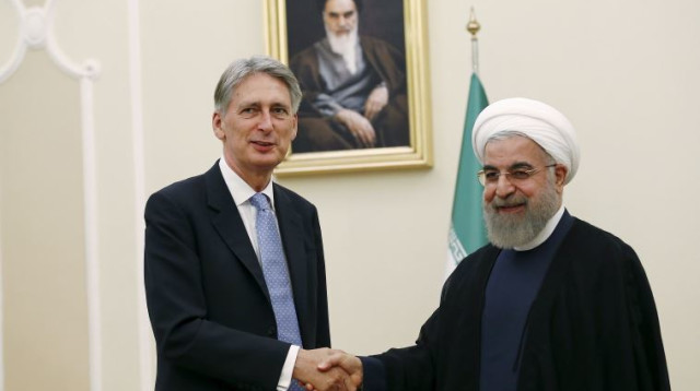 חסן רוחאני ופיליפ האמונד (צילום: רויטרס)