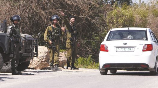 מחסום של צה"ל לאיתור שב"חים ליד קלקיליה, אתמול. הממשלה תקדם חקיקת בזק נגד מעסיקים ומסיעים של שוהים ב (צילום: AFP)