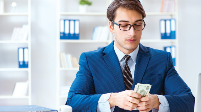 גבר בחליפה מחזיק כסף, צילום אילוסטרציה (צילום: אינג אימג')
