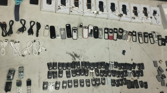 המכשירים הסלולרים שנתפסו בתחנת השיגור בבית לחם להברחתם לבית הכלא (צילום: דוברות שב"ס)