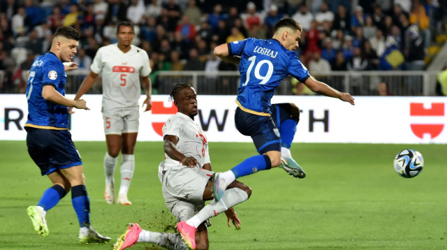 פלוריאן לושאי שחקן נבחרת קוסובו לפני דניס זקאריה שחקן נבחרת שוויץ (צילום: רויטרס)