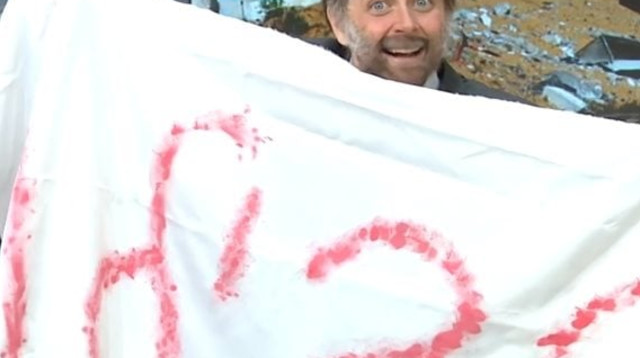 גאיה באר-גורביץ' כבצלאל סמוטריץ' והווילון משלט החטופים ב"ארץ נהדרת" (צילום: צילום מסך קשת 12)