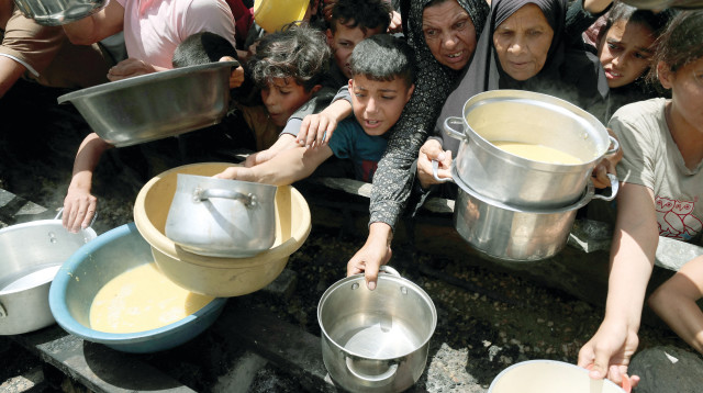 עזתים מתחננים למנת מזון (צילום: רויטרס)