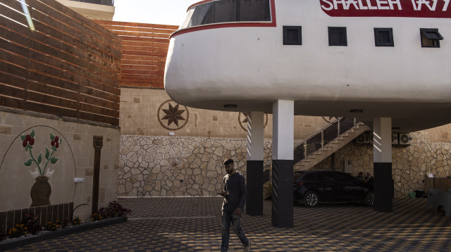 בית נופש בצורת מטוס מול גדר ההפרדה (צילום: JOHN WESSELS/AFP via Getty Images)