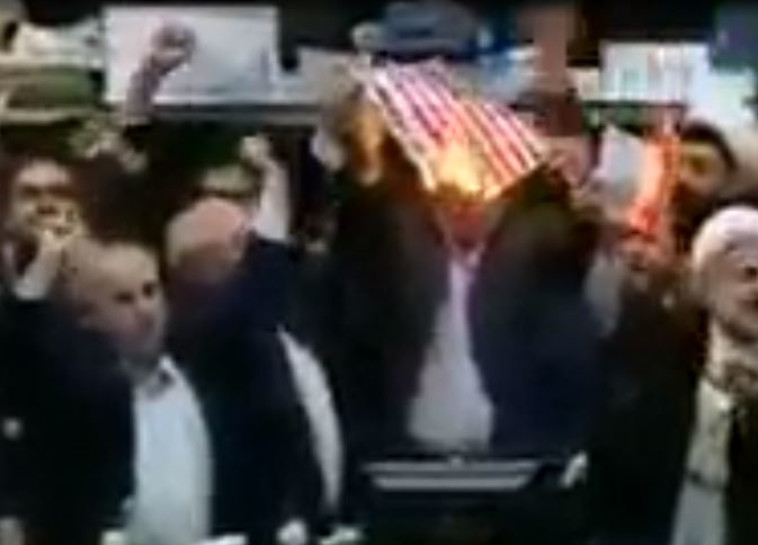 חברי פרלמנט איראנים שורפים את דגל ארה"ב. צילום מסך