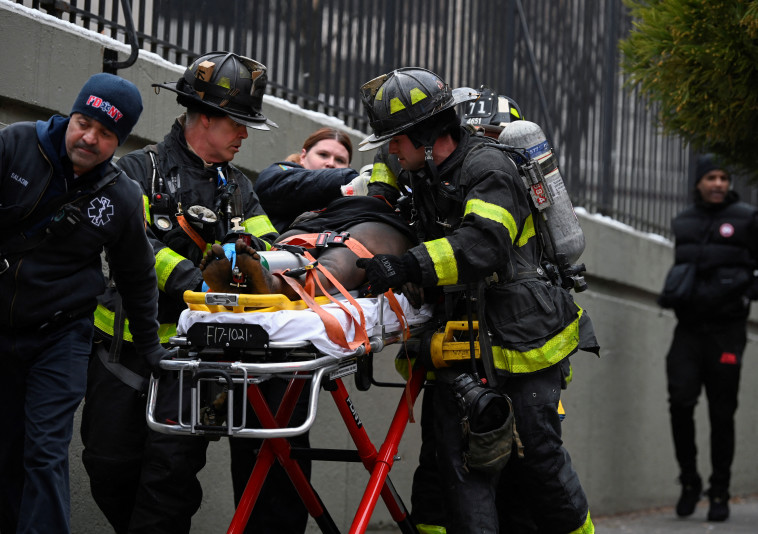 Rescuers at the huge fire in the Bronx, New York (Photo: Reuters)