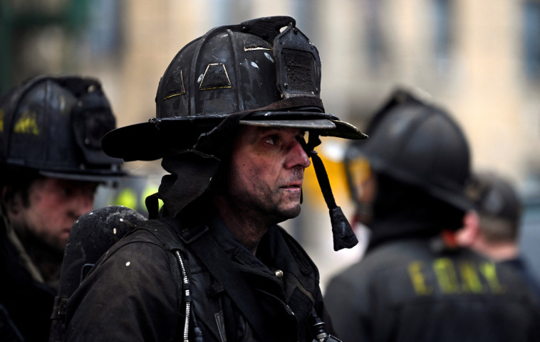 Rescuers at the huge fire in the Bronx, New York (Photo: Reuters)