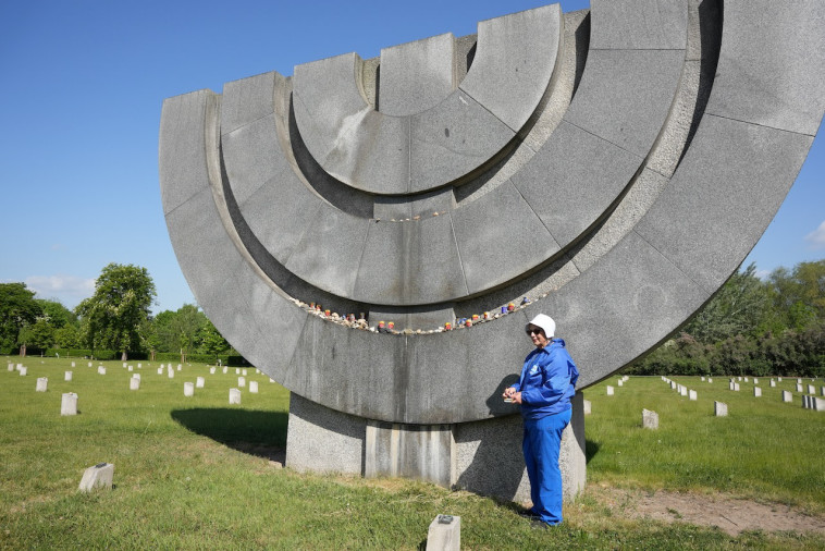 בת הדור השני לשואה מדליה נר נשמה באנדרטה במחנה טרזין (צילום: דייל בלוסטיין)