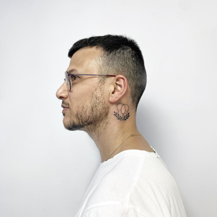 אסי עזר בסטודיו של המקעקעת שרה קורי